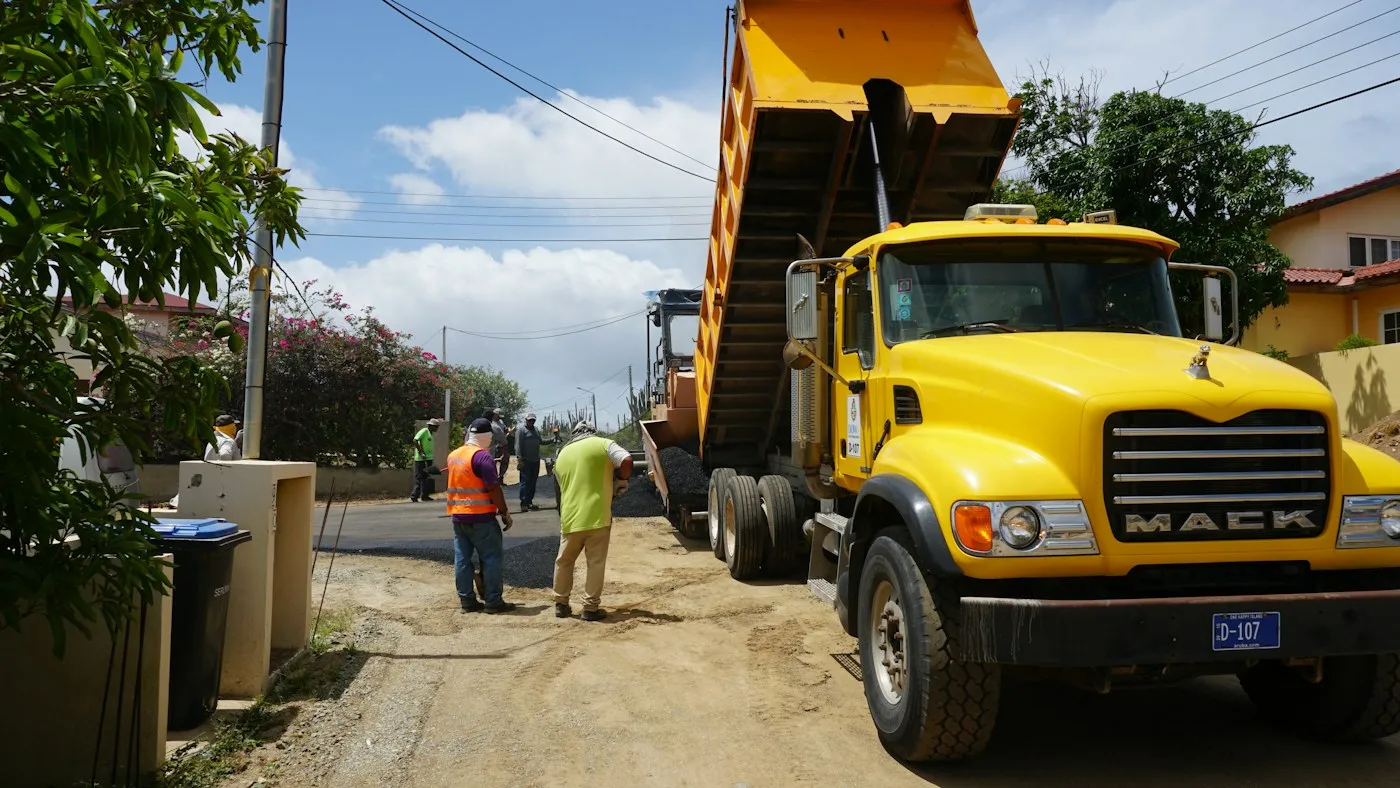 Dump truck and workers at a worksite